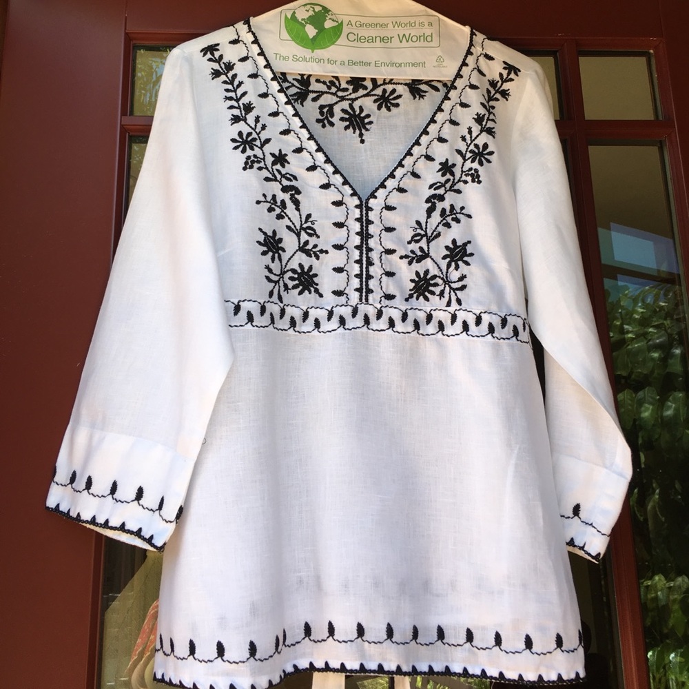 Medium white linen embroidered blouse.