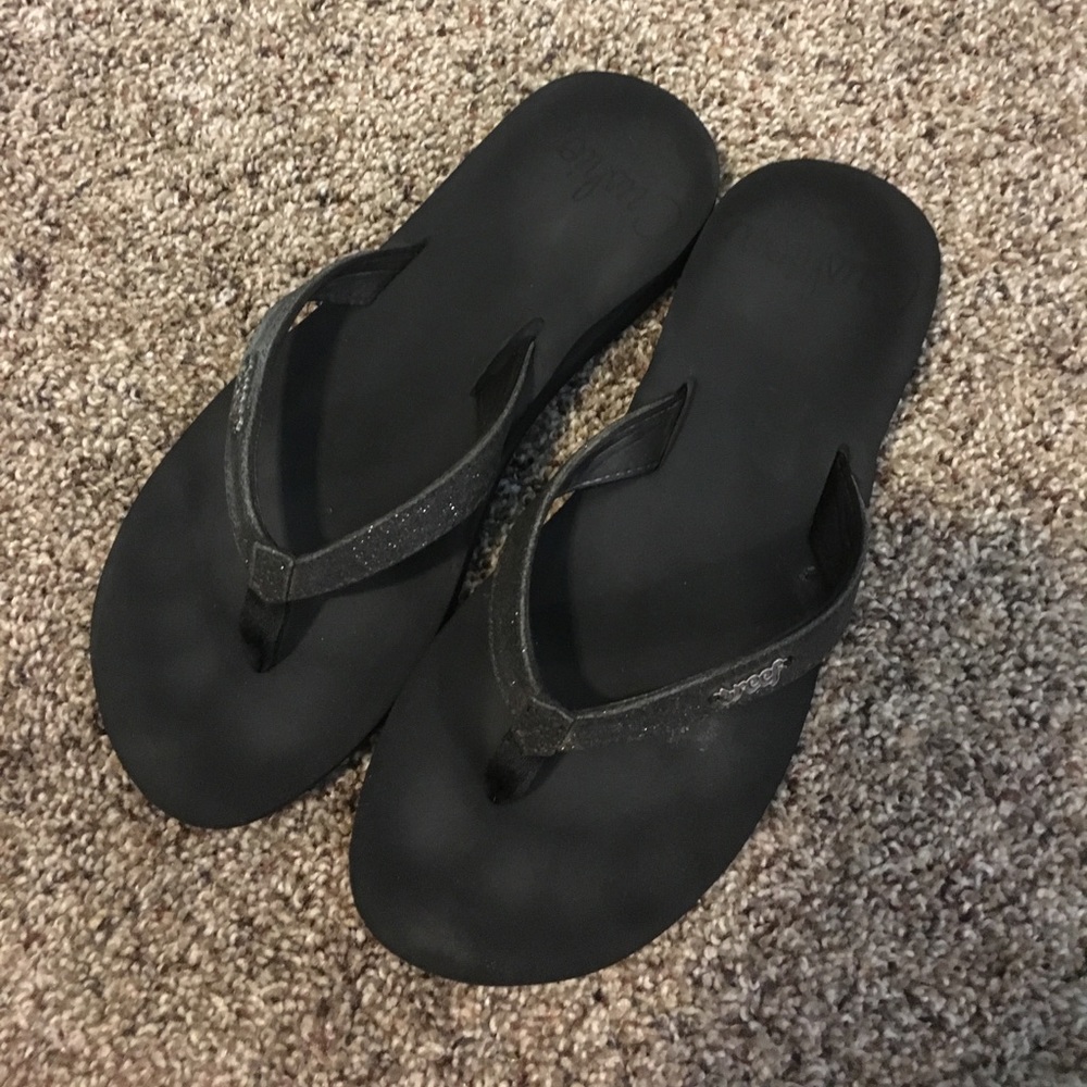 Black cushioned flip flops