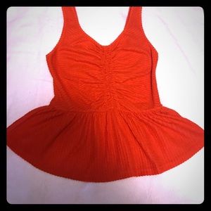 Orange, rouched sleeveless top.