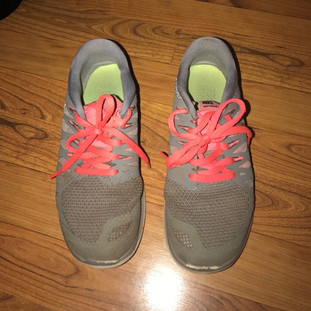 grey and pink Nike tennis shoes
