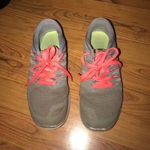 grey and pink Nike tennis shoes