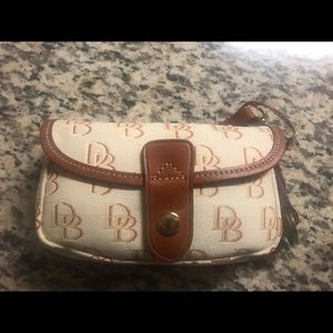 Authentic Dooney and Bourke flap wristlet.