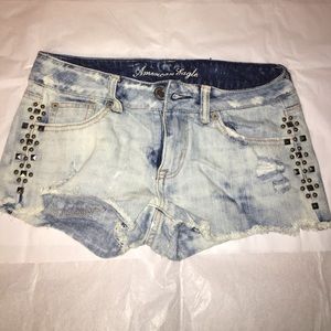 Light wash ripped jeans with stones on the sides