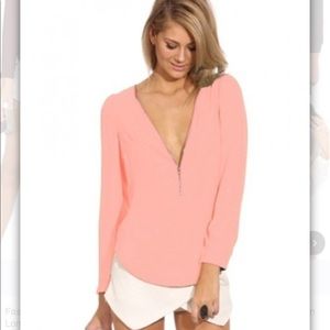 Light pink zip blouse.