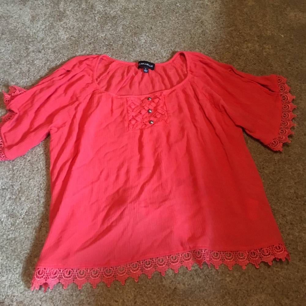 A coral/orange cold shoulder shirt