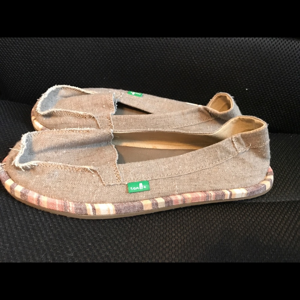 Sanuk shorty wrapped tan shoes.