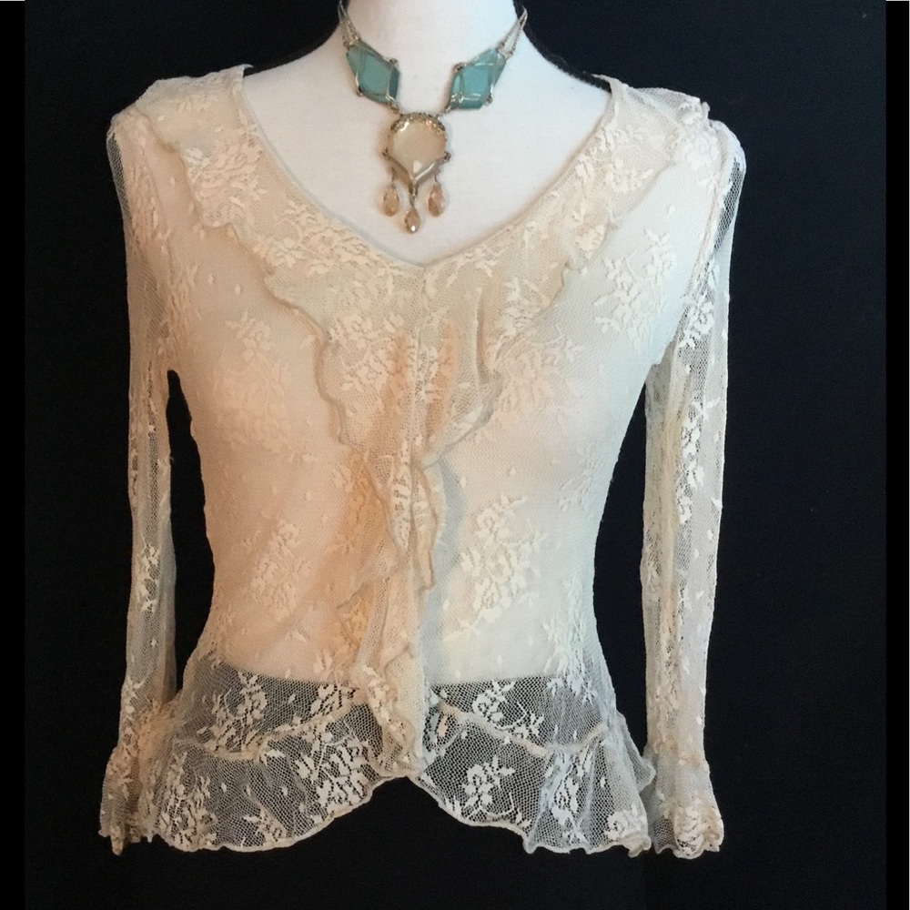 Delicate Sheer Lace Top with Ruffle Details.
