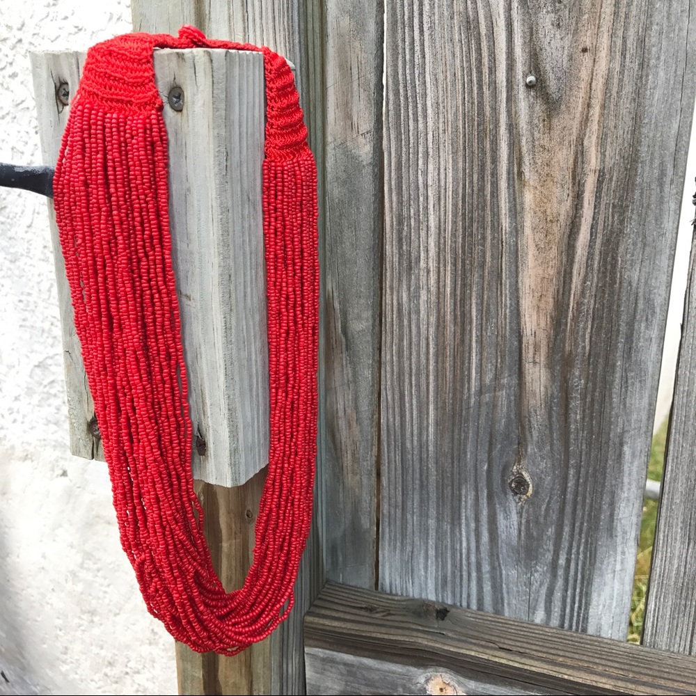 Multi-strand beaded necklace with button closure.