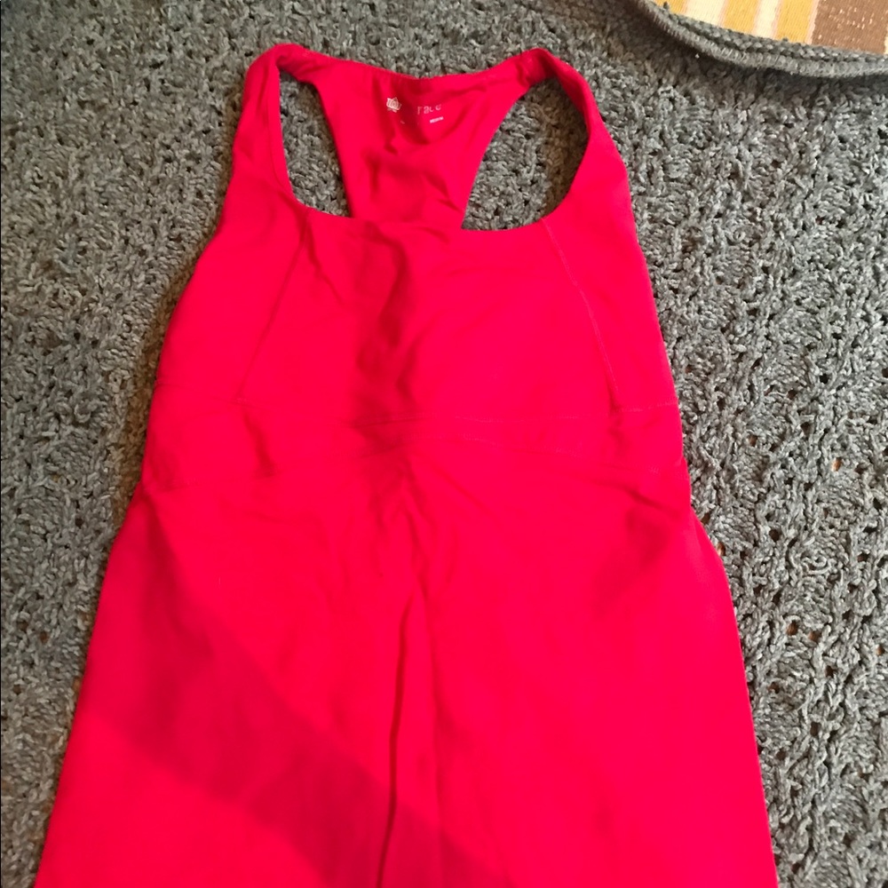 Kira Grace red workout top.