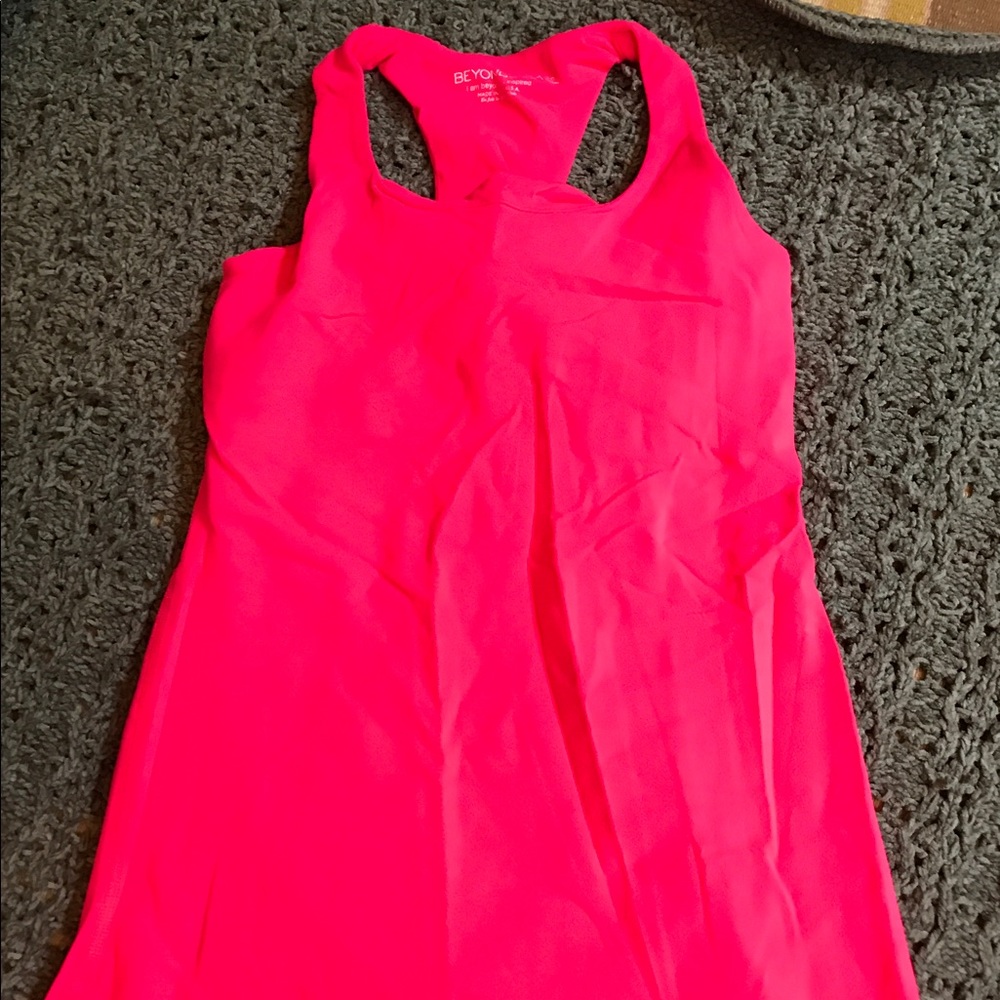Pinkish/orange beyond yoga tank.