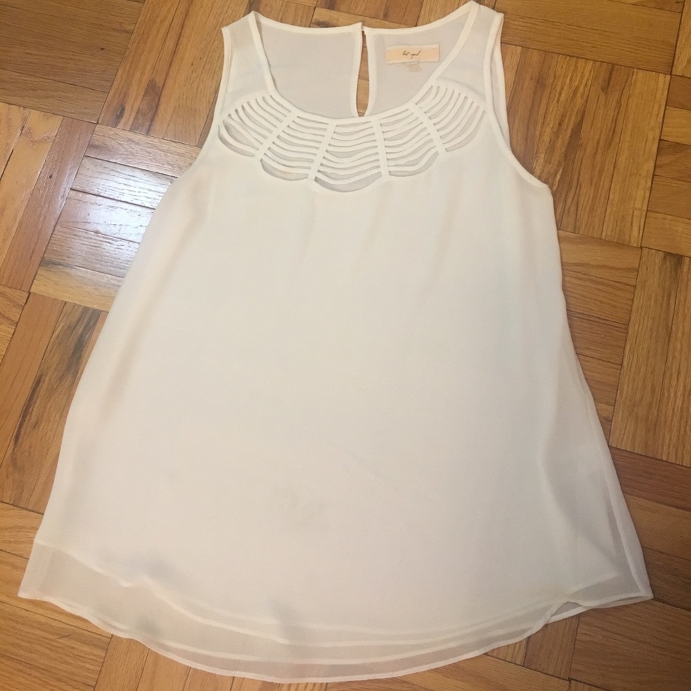 White top with detailed neckline.