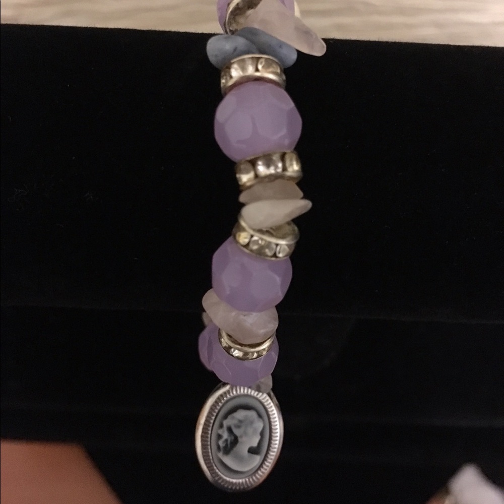 Glass beaded bracelet with silhouette charm.