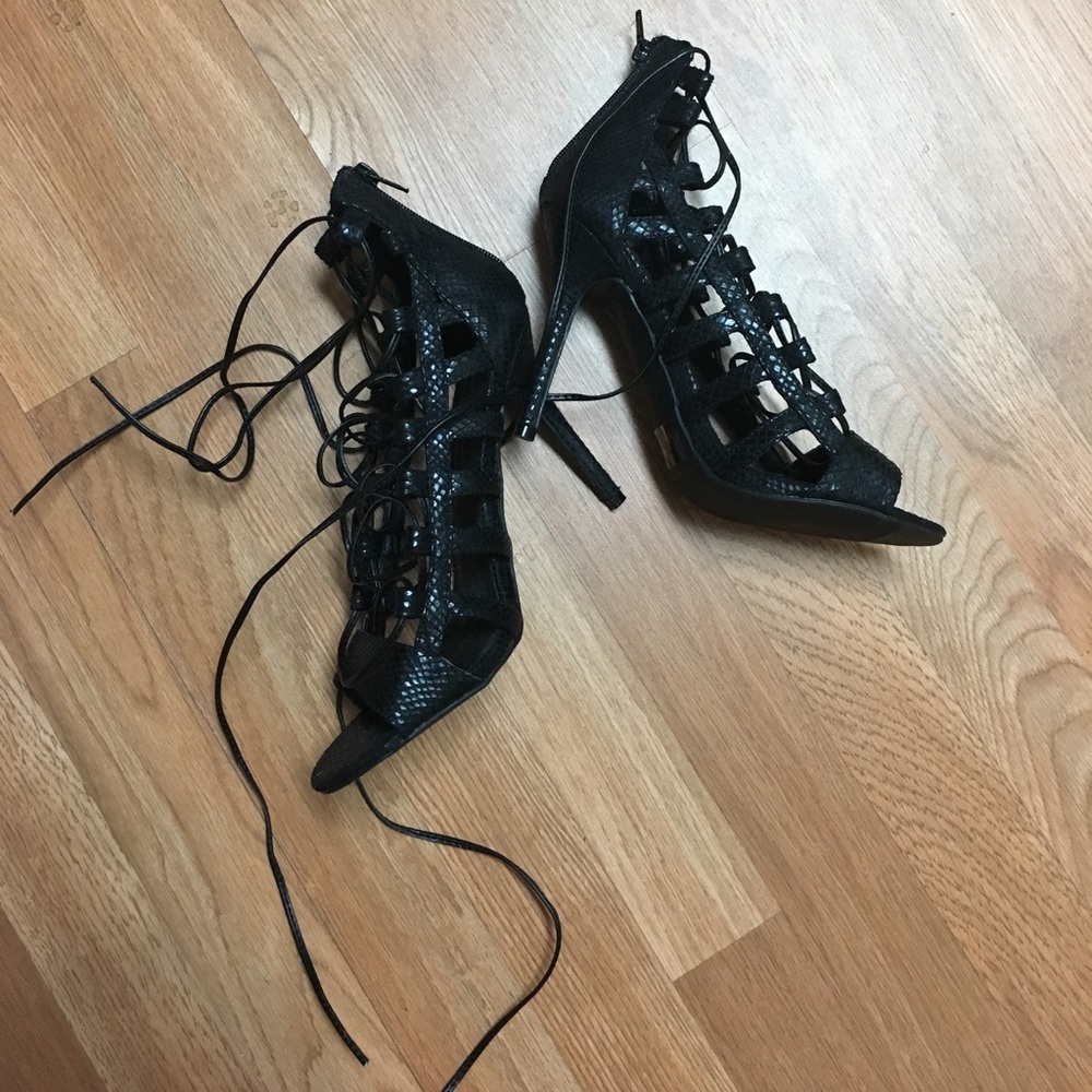 Laced up black all leather heels.