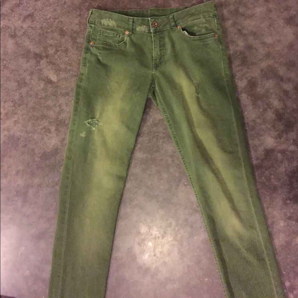 Distressed green jeans