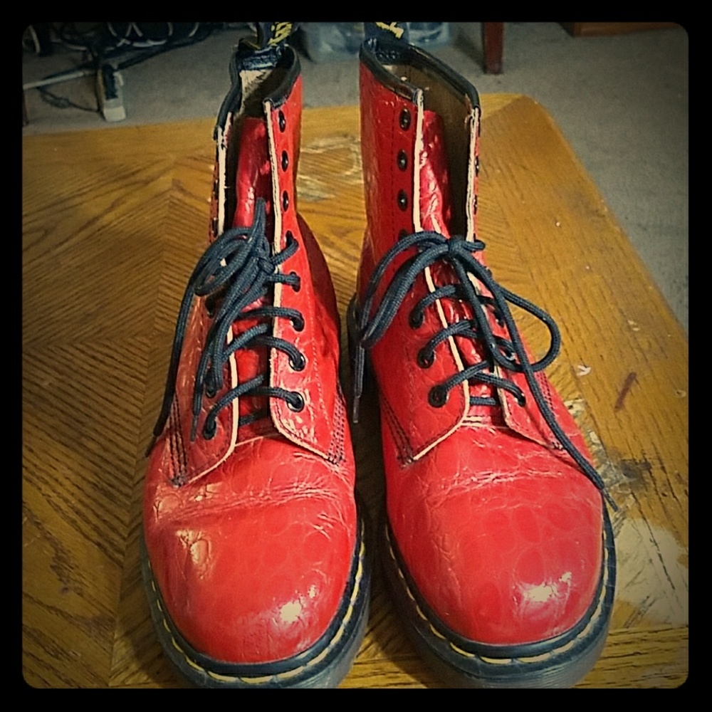 Dr. Martens size 9 red textured hightop shoes.
