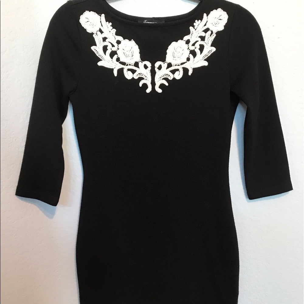 Short black dress with white embroidery