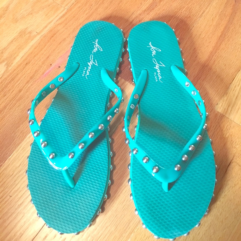 Isa Tapia flip flops with sliver studs