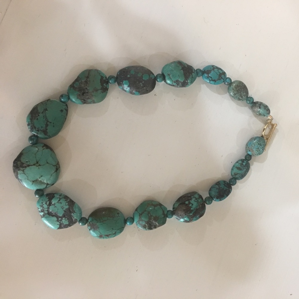 Natural blue green turquoise with black matrix.