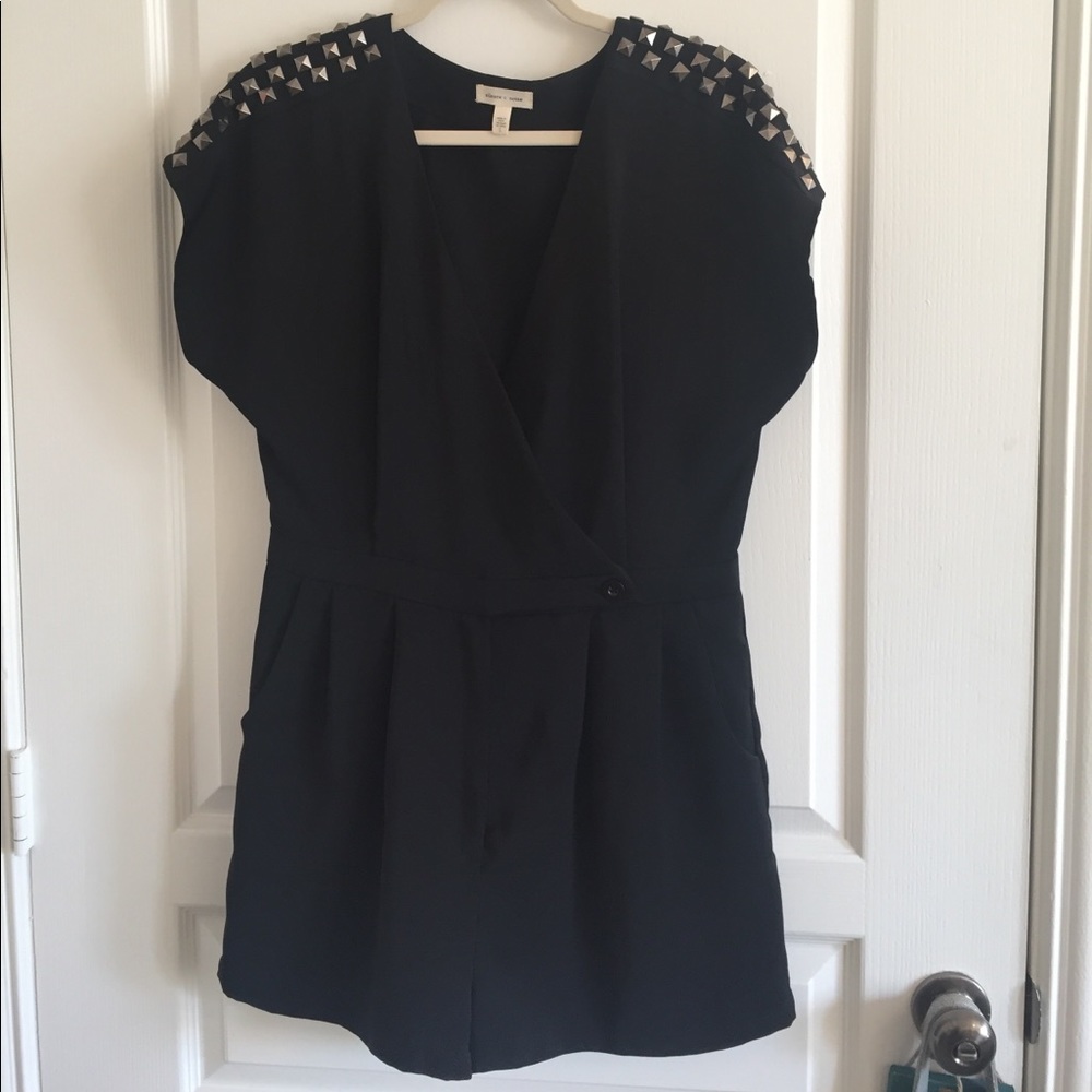 Black romper with studded shoulders.