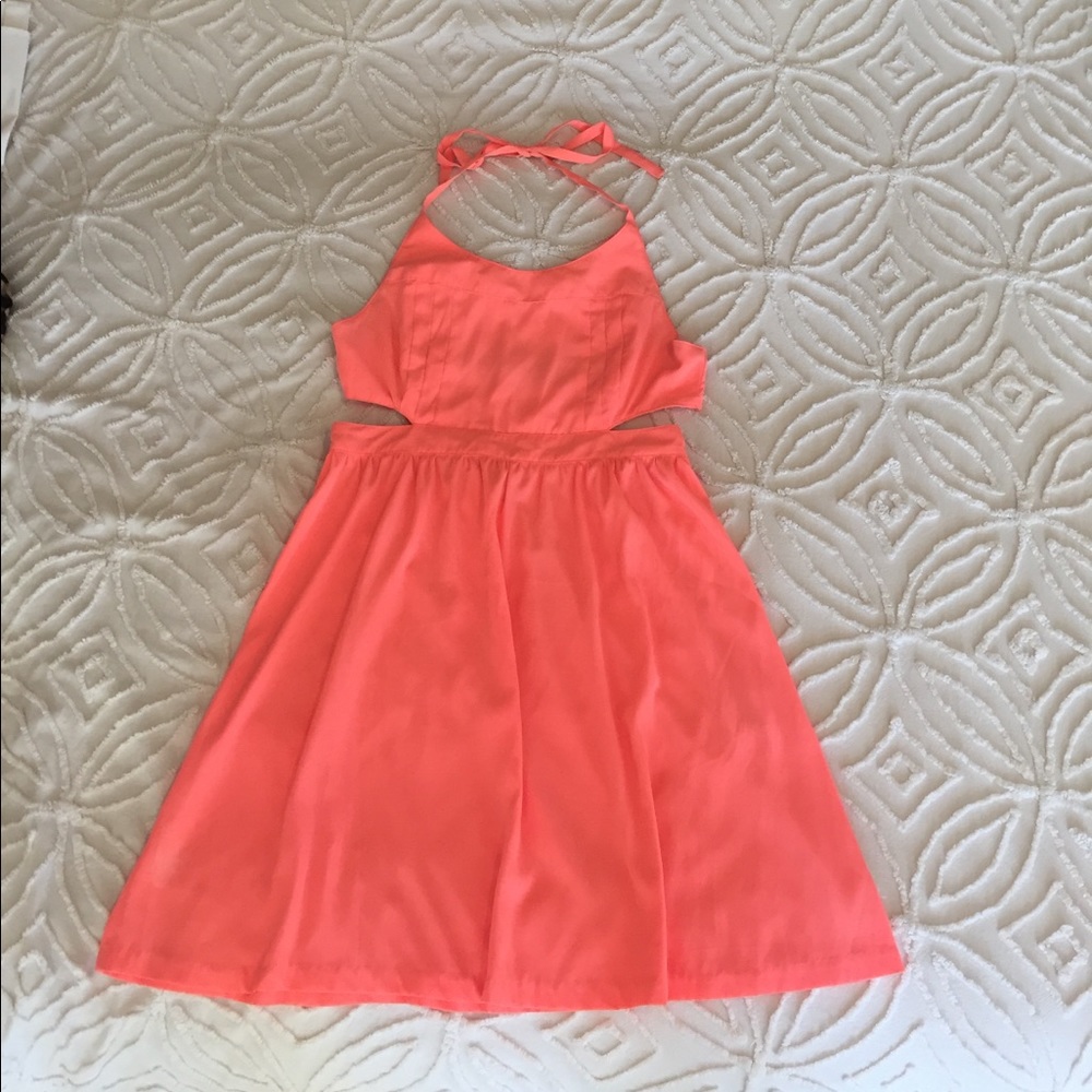 Coral dress with open back.