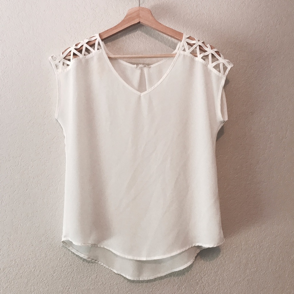White blouse with cut out triangle sleeve details