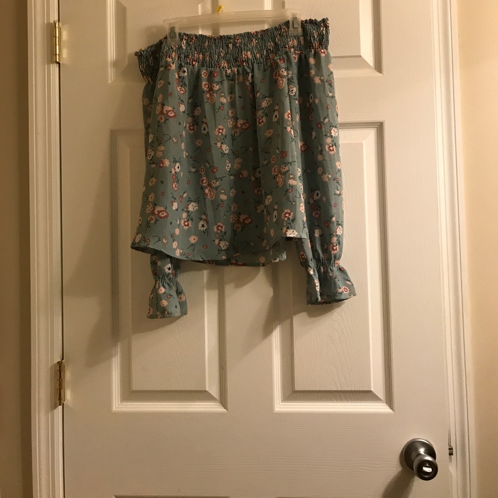 Beautiful shirt that hangs of shoulder