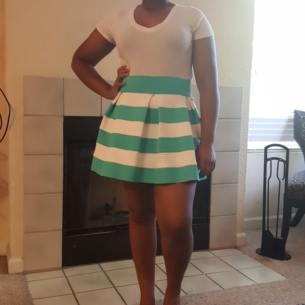 Pleated turquoise and white striped skirt.