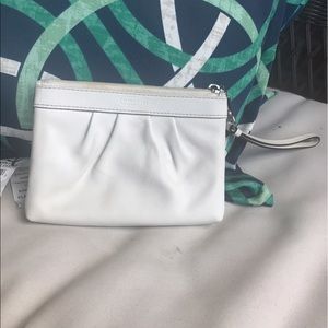 White leather Coach wristlet.