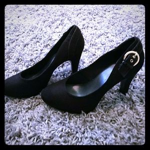 Black heels with gold buckle.