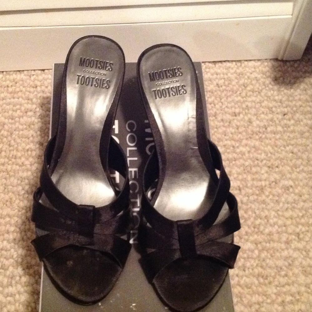 Slightly worn black strapped shoes