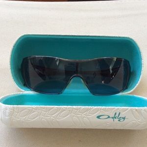 Gunmetal gray Oakley shades with minor scratches