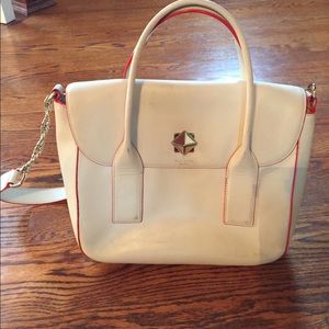 White Kate Spade bag with coral edging.