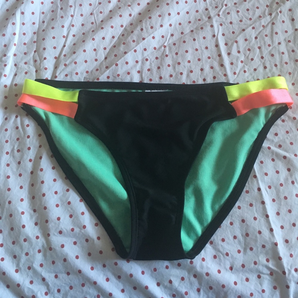 Black swim suit bottoms, yellow and pink details.