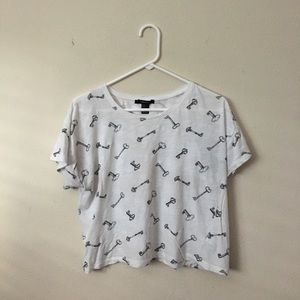 White crop top with assorted key graphics