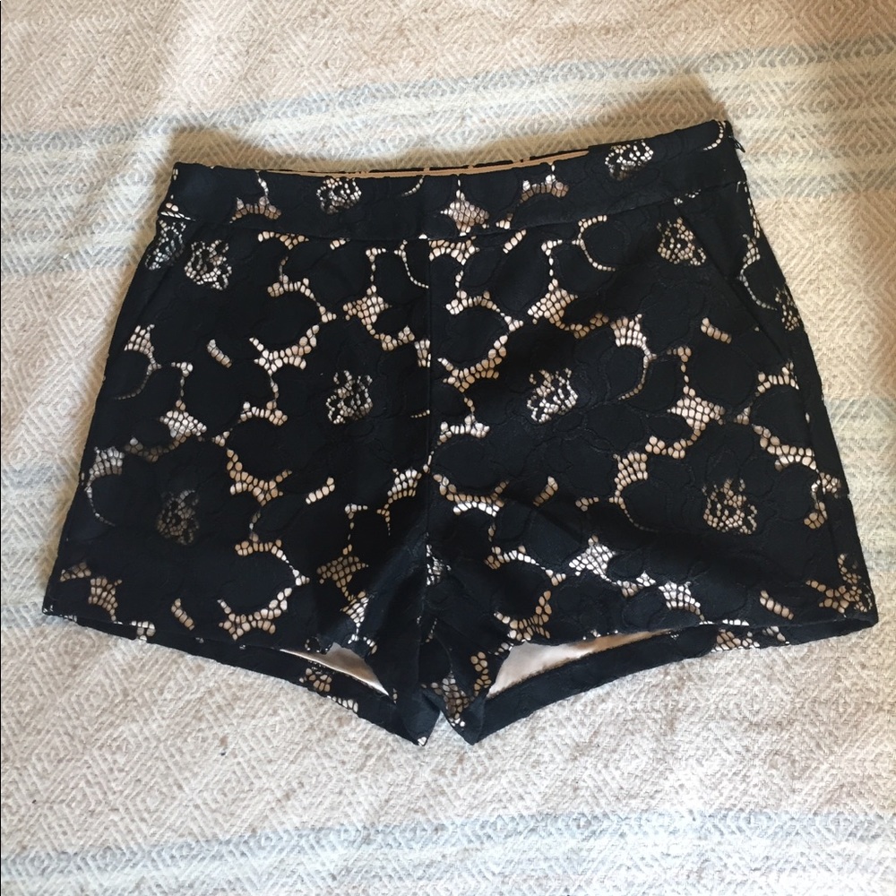 Express black lace over nude shorts