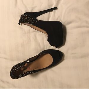 Black faux suede heels with gold accents