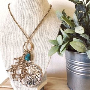 Beach inspired gold necklace with large charms