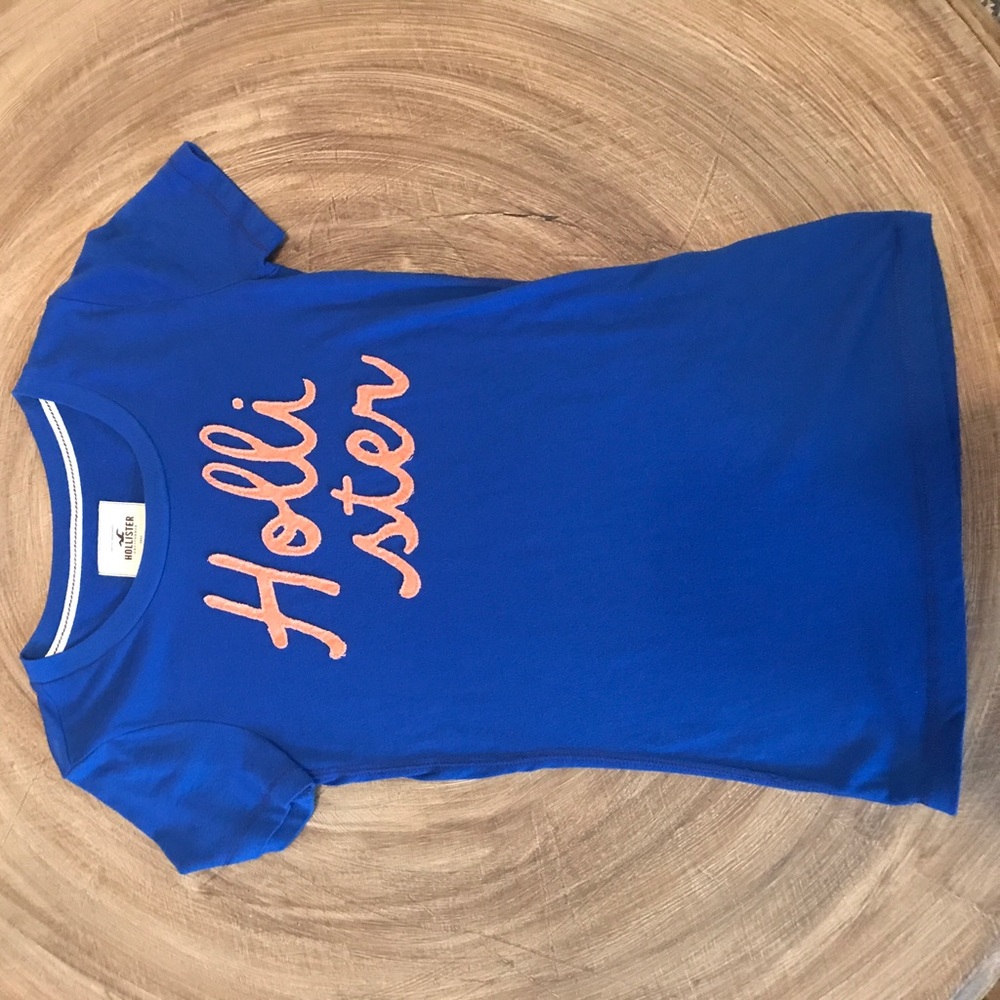 Royal Blue Shirt with Orange Writing.