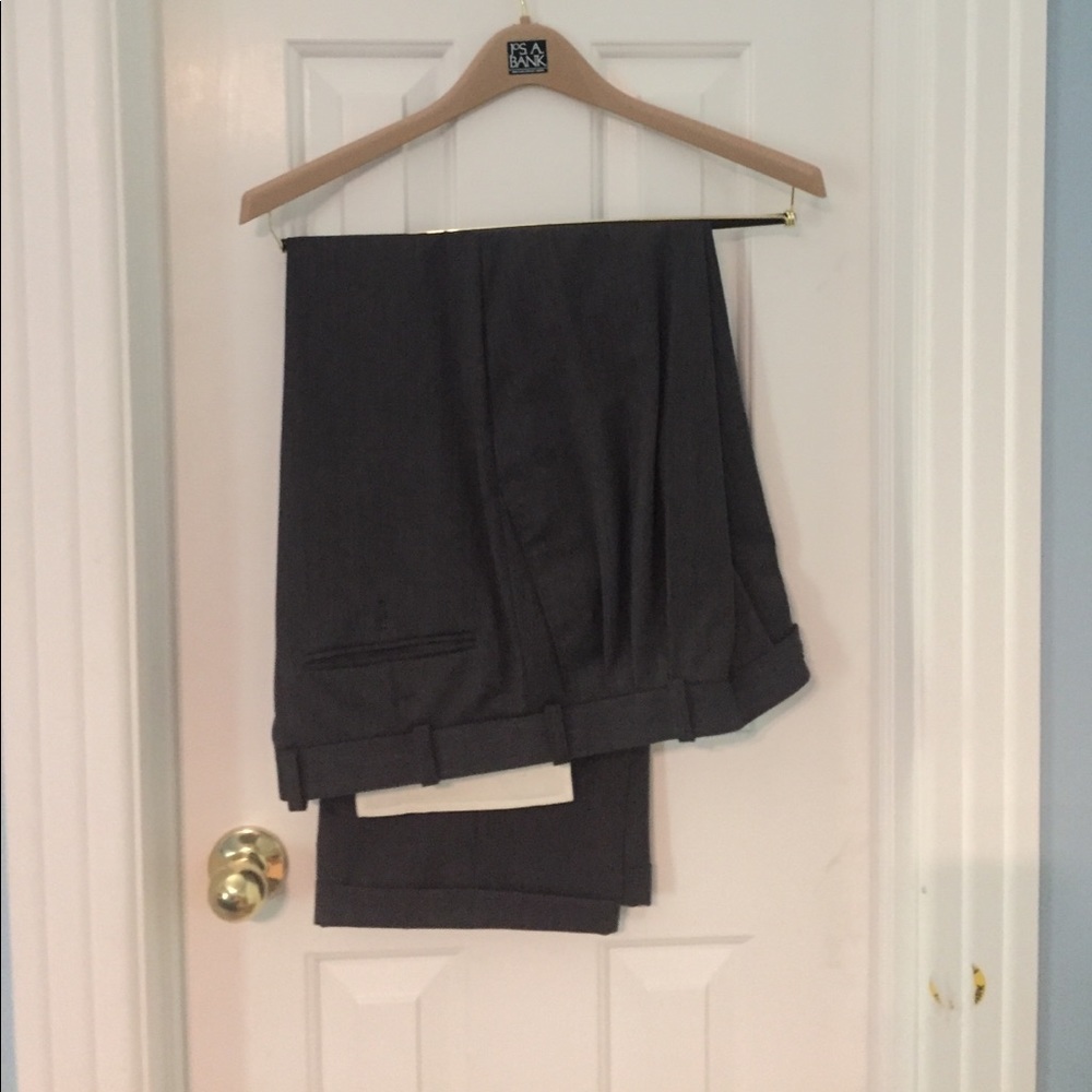 Dark gray suit with pleated pants. Like new.