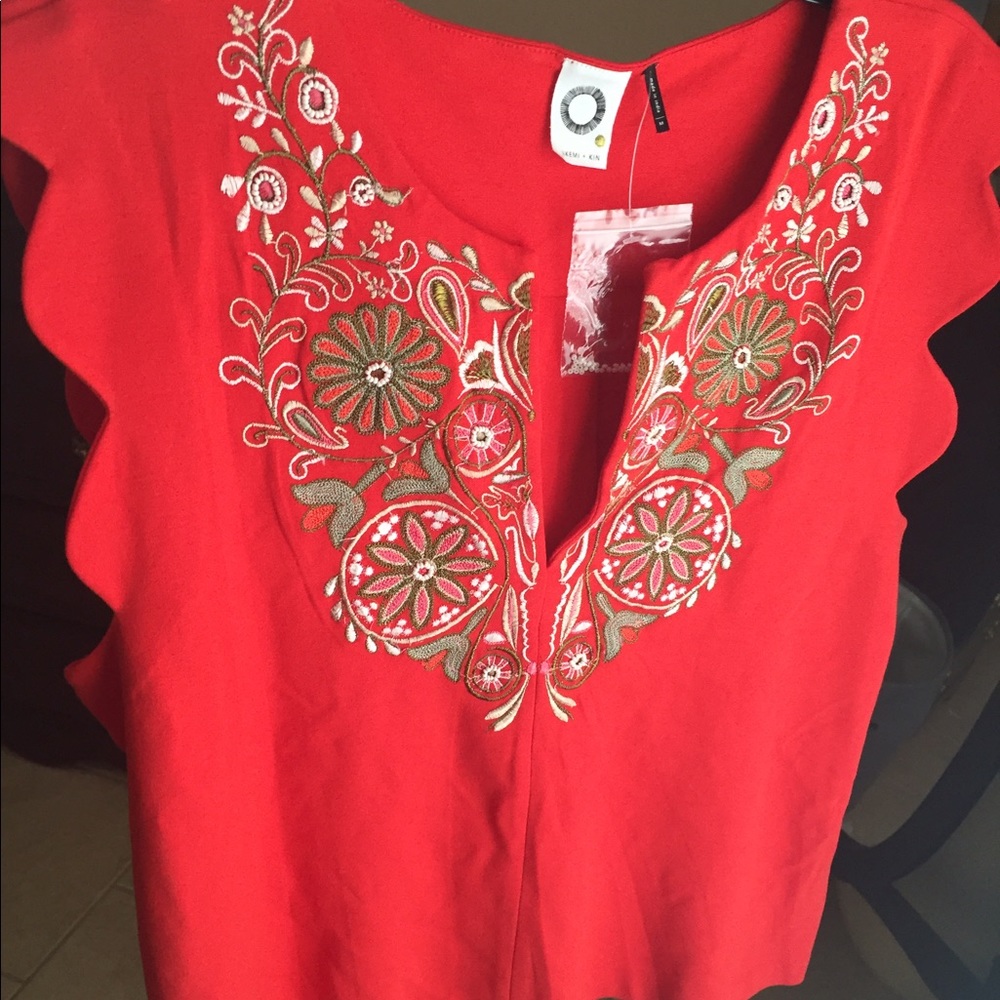 Red shirt with beading and embroidery.