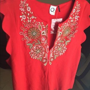 Red shirt with beading and embroidery.