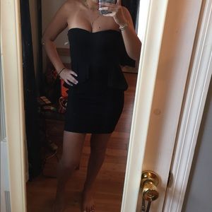 Black peplum body con dress.