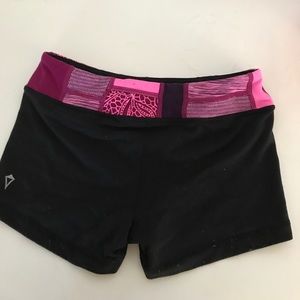 black shorts with a reversible pink waist band