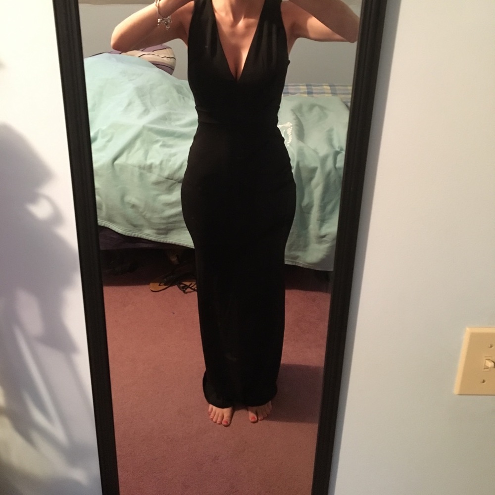NEW, never worn. Long black dress, fitted.