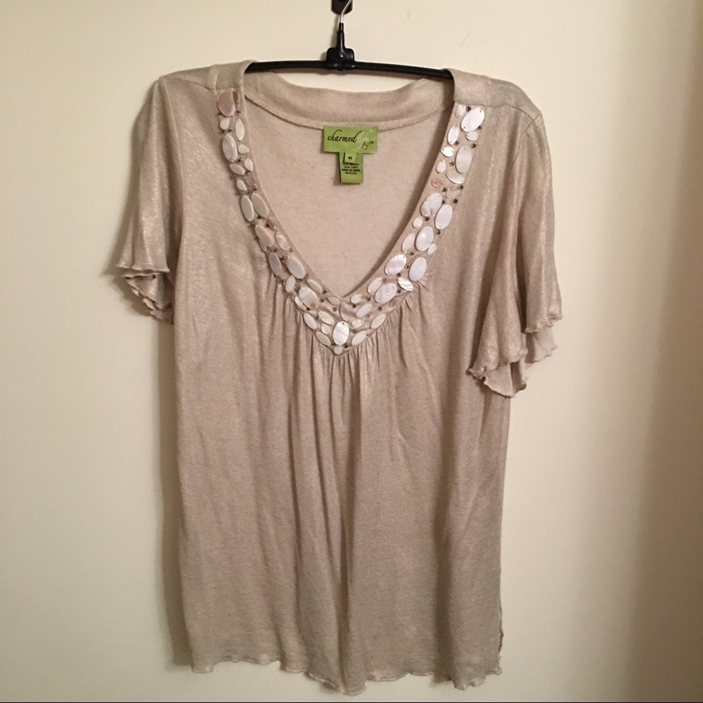 Unique shimmery top with shell design at neckline
