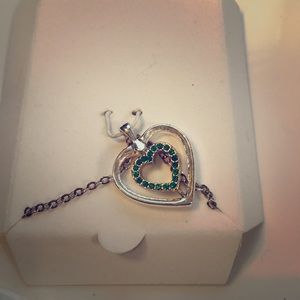 Silver/gold emerald stones reversible necklace.