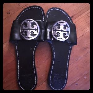 Gently worn patent leather sandals.