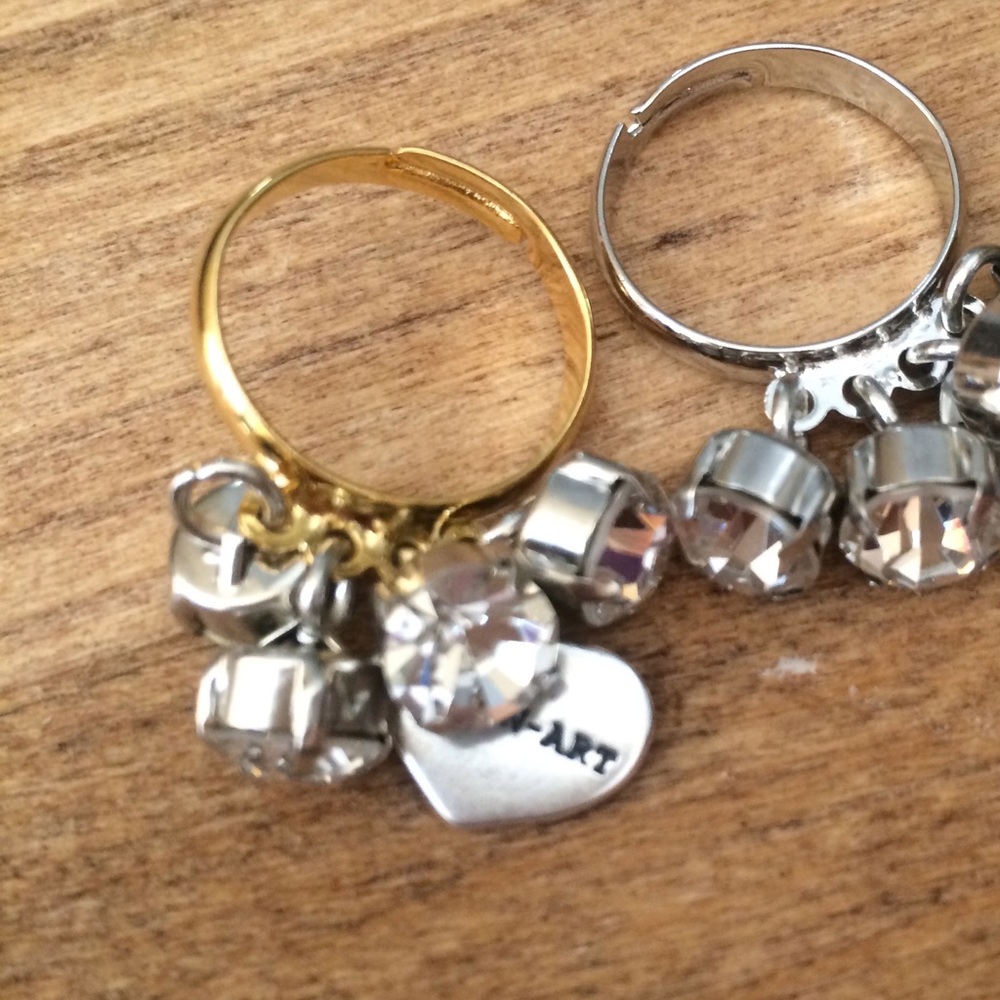 Adjustable charm ring in gold and silver color.