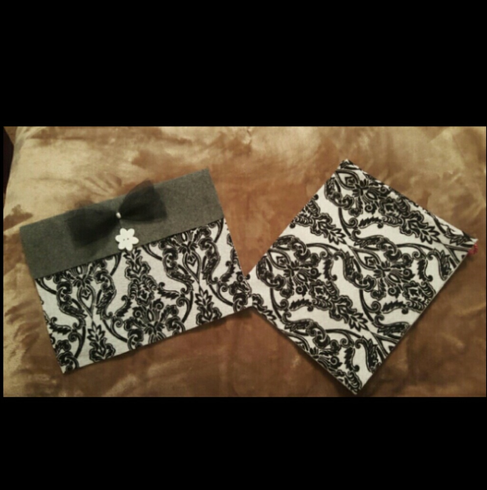 Two matching black and white carry out bags
