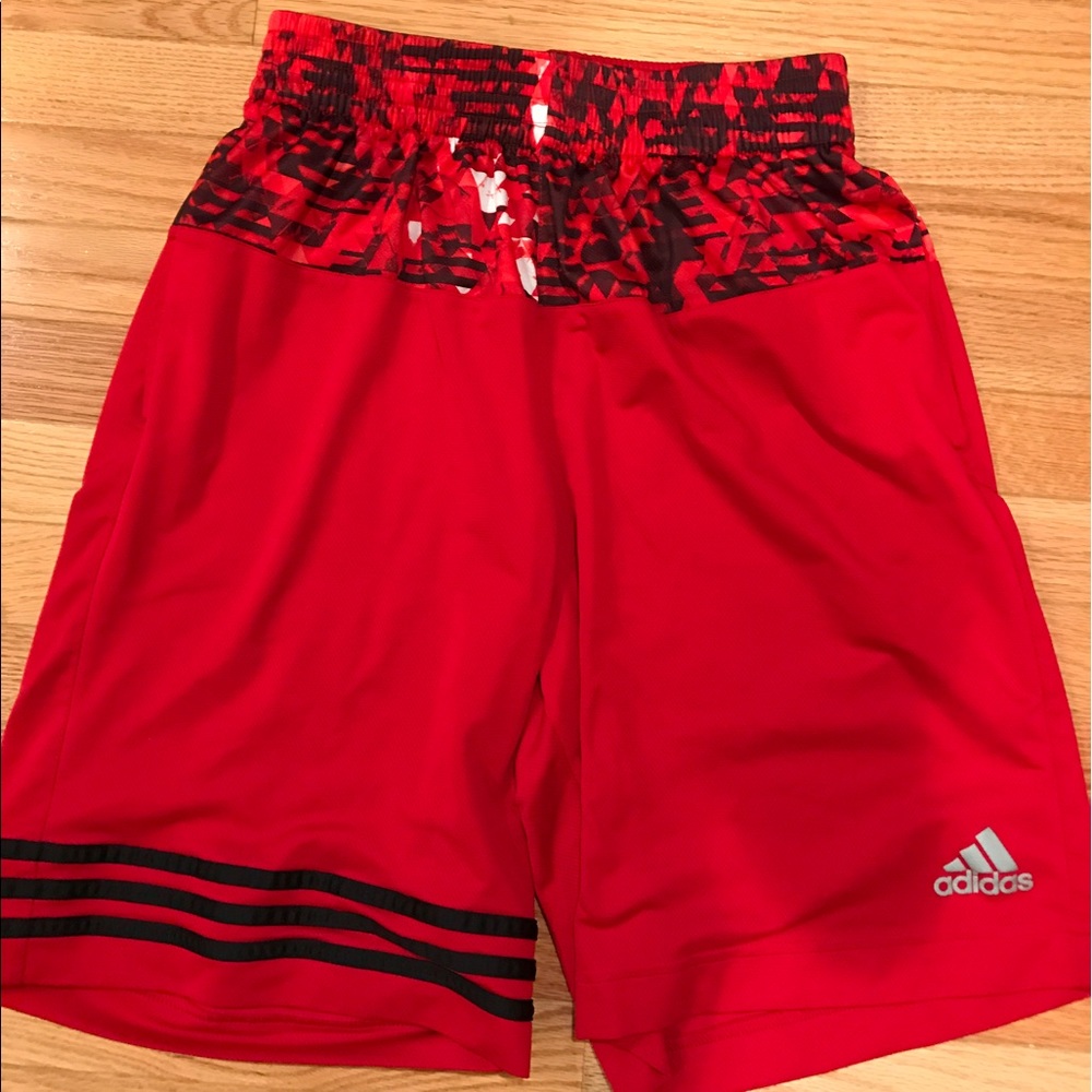 Red Adidas shorts.